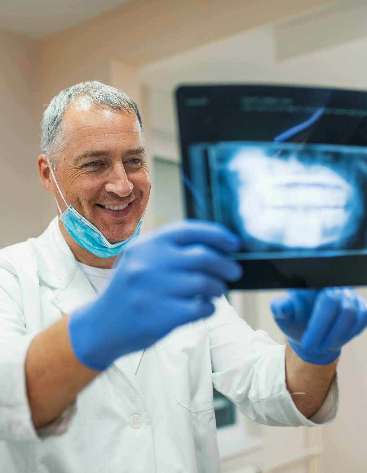 Day One dental clients dentist looking at a panoramic X-ray of an implant patient